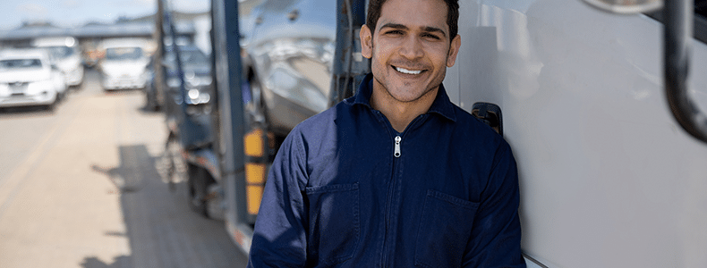 Trustworthy vehicle shipping service provider standing by truck
