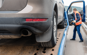 How Does Bring a Trailer Work 1 shot of a car on a flatbed truck while the carrier is in background getting ready for transport